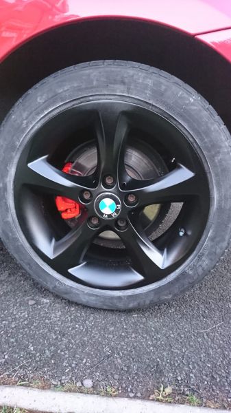 Satin black wheels and red calipers on a BMW 1 series in Forest Town, Mansfield: Swipe To View More Images